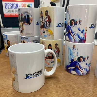 Group of custom printed mugs featuring photo designs and one plain mug with a logo.
