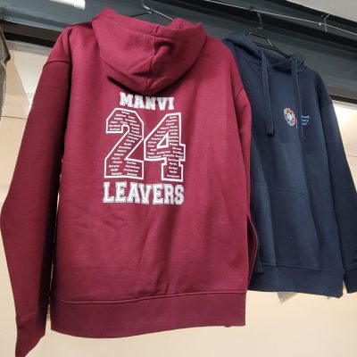 Burgundy hoodie with white text “MAMVI 24 LEAVERS” printed on the back, hanging next to a navy hoodie.